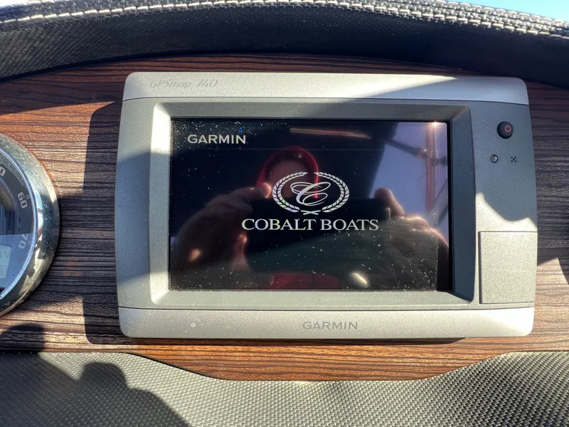 Slide: The Image of Garmin display on 2014 Cobalt R5 boat dashboard with Cobalt Boats logo. - 30