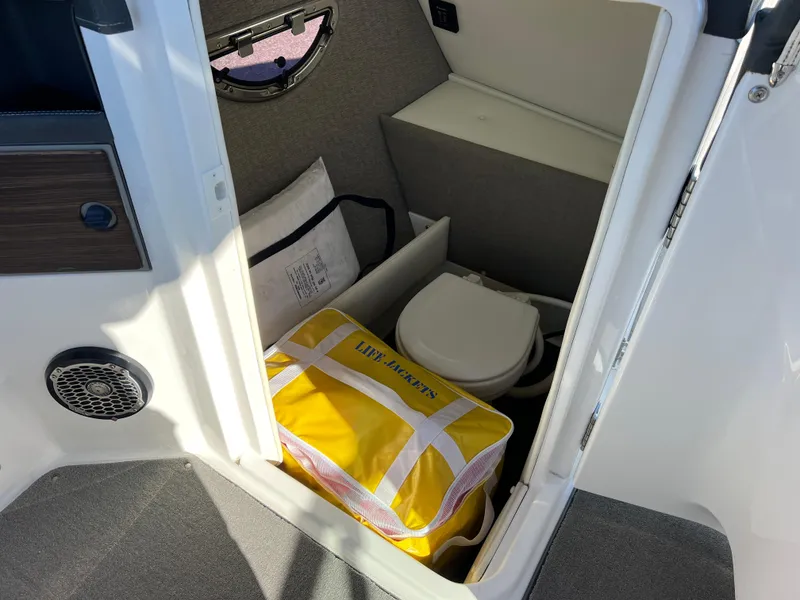 Slide: The Image of 2014 Cobalt R5 boat interior with life jackets and toilet compartment. - 35