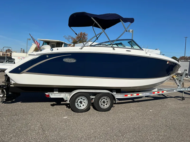 Slide: The Image of 2014 Cobalt R5 boat on trailer, blue and white design, parked outdoors. - 4