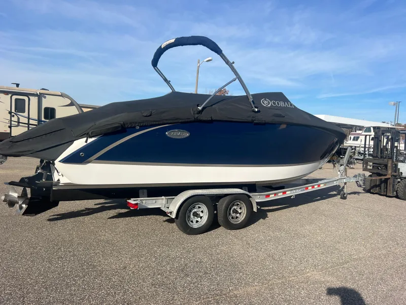Slide: The Image of 2014 Cobalt R5 boat on trailer with cover, parked outdoors. - 47