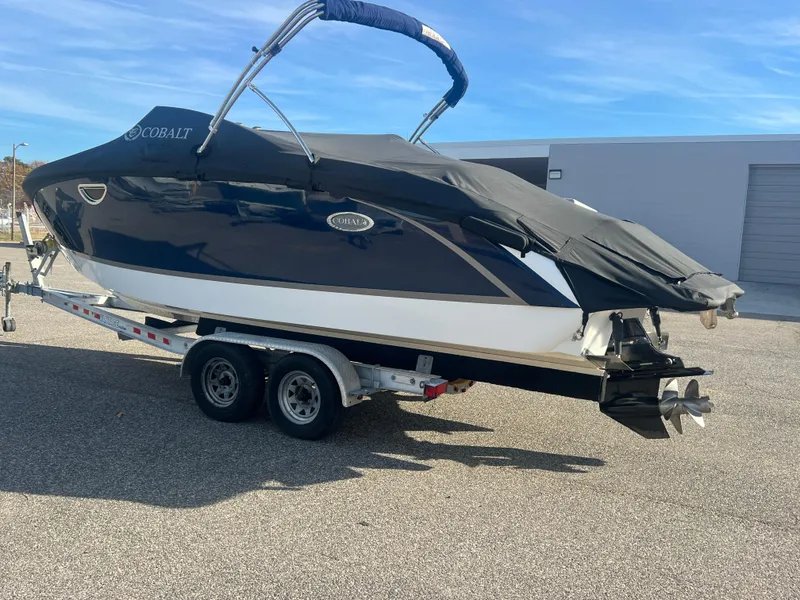 Slide: The Image of 2014 Cobalt R5 boat on trailer, covered, parked outdoors. - 48