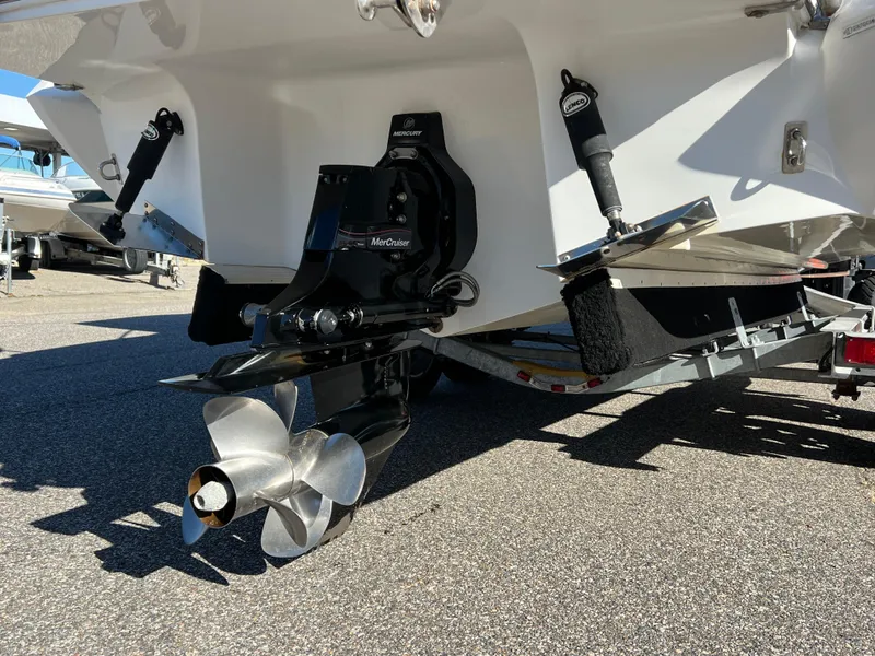 Slide: The Image of 2014 Cobalt R5 boat on trailer, blue and white design, parked outdoors. - 6