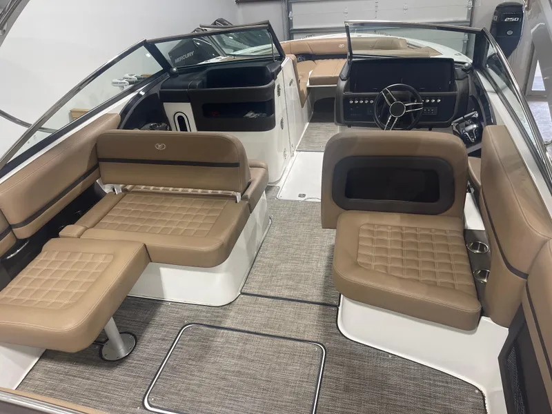 Slide: The Image of 2022 Cobalt 30 SC boat interior with tan seating and modern dashboard. - 10