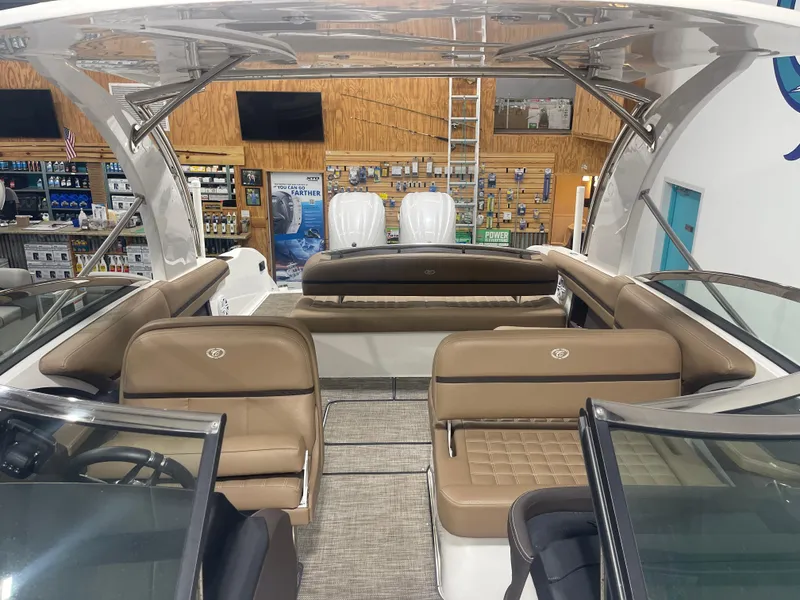 Slide: The Image of 2022 Cobalt 30 SC boat interior with tan seating and modern design in showroom. - 13