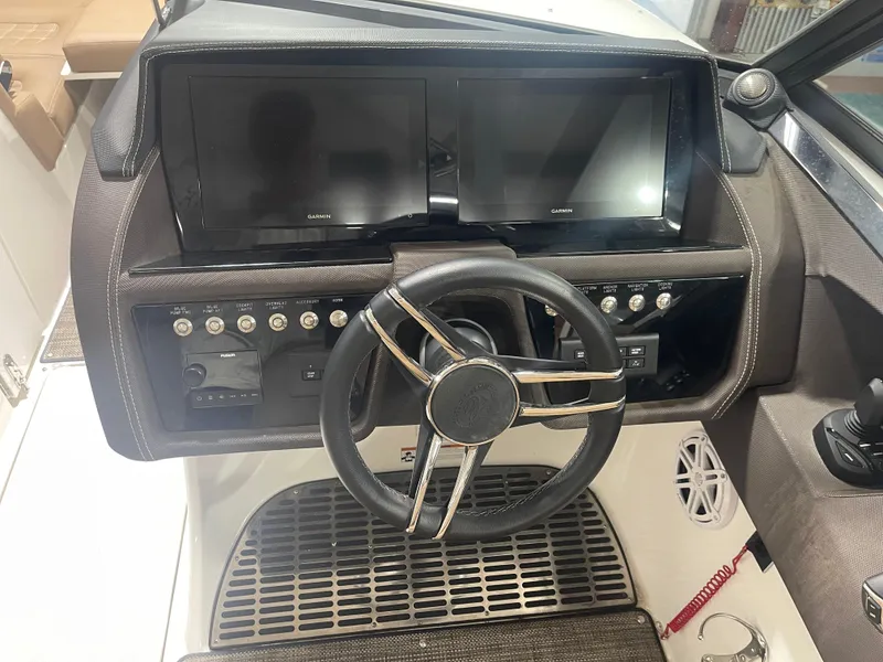 Slide: The Image of 2022 Cobalt 30 SC boat dashboard with dual Garmin displays and steering wheel. - 14