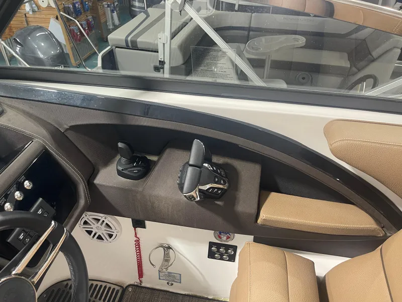 Slide: The Image of Interior of 2022 Cobalt 30 SC boat, featuring steering controls and beige seating. - 15