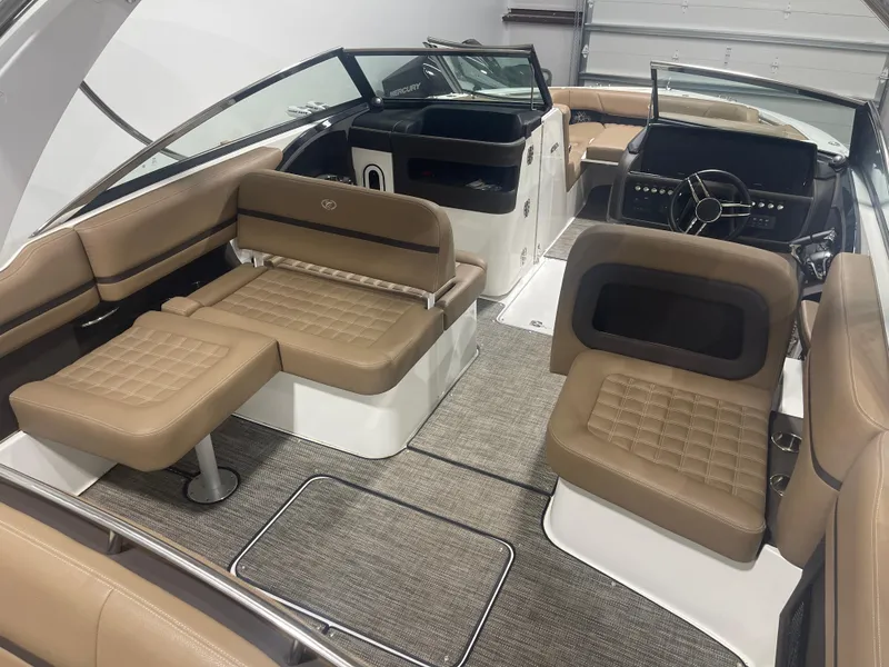 Slide: The Image of 2022 Cobalt 30 SC boat interior with tan leather seating and modern dashboard. - 18
