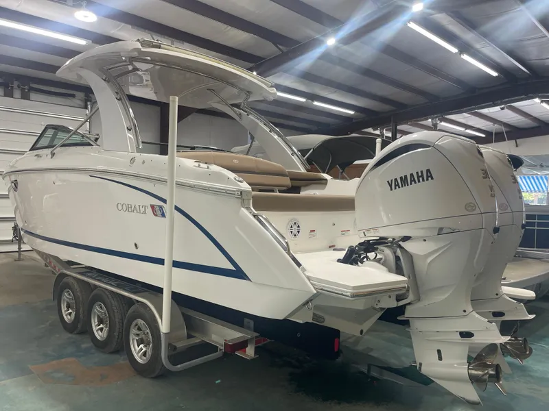 Slide: The Image of 2022 Cobalt 30 SC boat with Yamaha engines in a warehouse setting. - 6