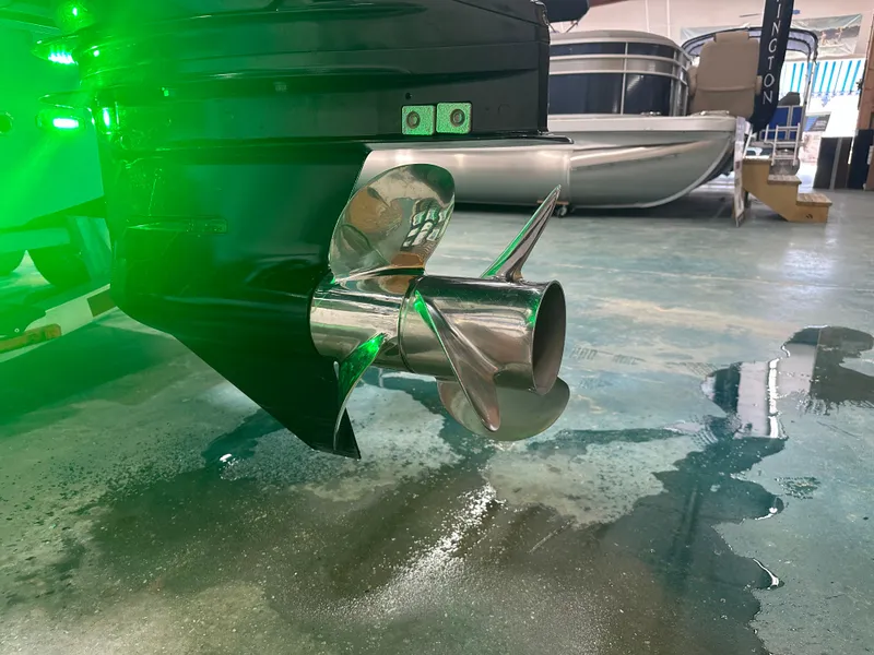 Slide: The Image of 2023 Sea Born FX 25 boat propeller with green lighting in a showroom. - 11