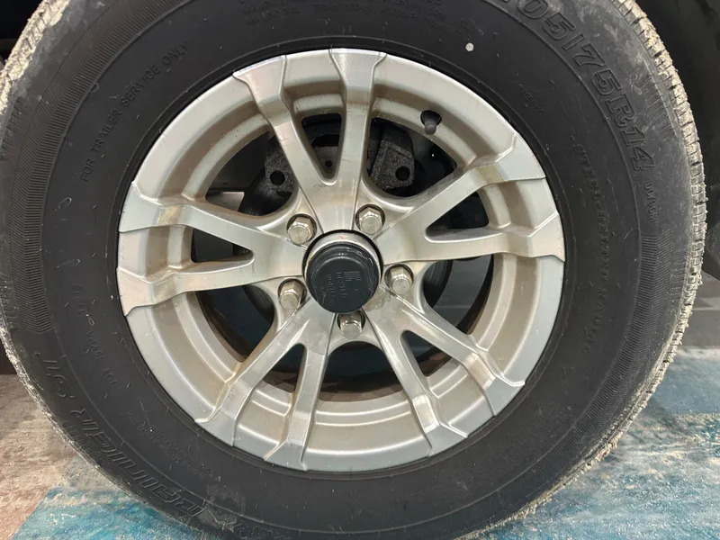 Slide: The Image of Close-up of a 2023 Sea Born FX 25 trailer wheel and tire. - 15