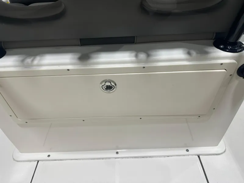 Slide: The Image of 2023 Sea Born FX 25 boat storage compartment with secure latch. - 19