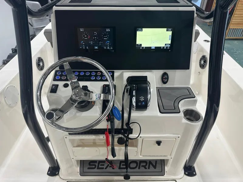 Slide: The Image of 2023 Sea Born FX 25 boat console with steering wheel and navigation screens. - 21