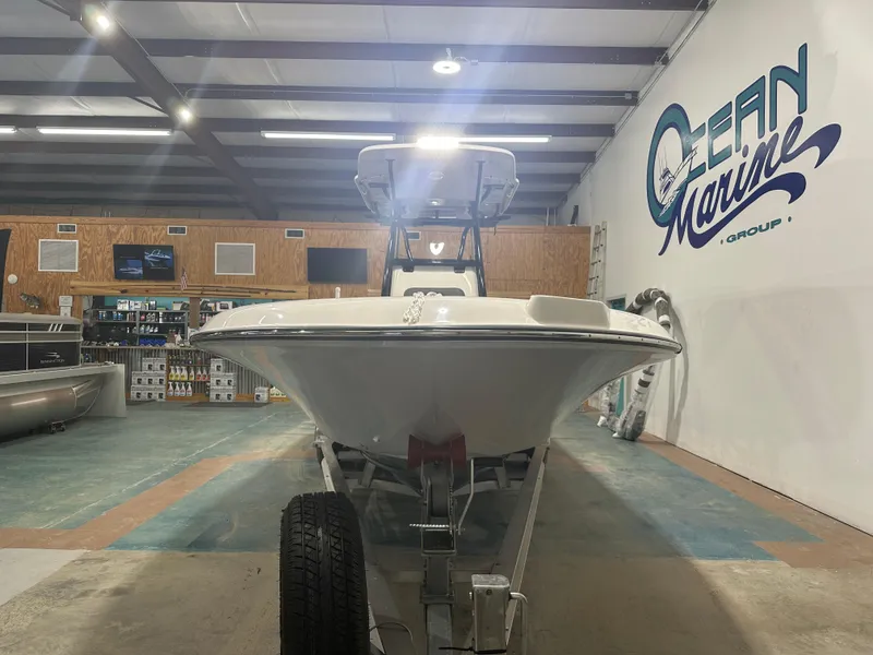 Slide: The Image of 2023 Sea Born FX 25 boat displayed indoors at Ocean Marine Group showroom. - 3