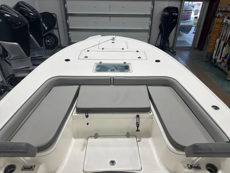 Slide: The Image of 2023 Sea Born FX 25 boat interior with cushioned seating and storage compartments. - 33