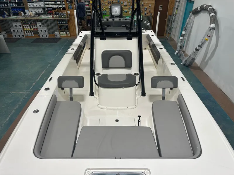 Slide: The Image of 2023 Sea Born FX 25 boat interior with gray seating in a showroom. - 34