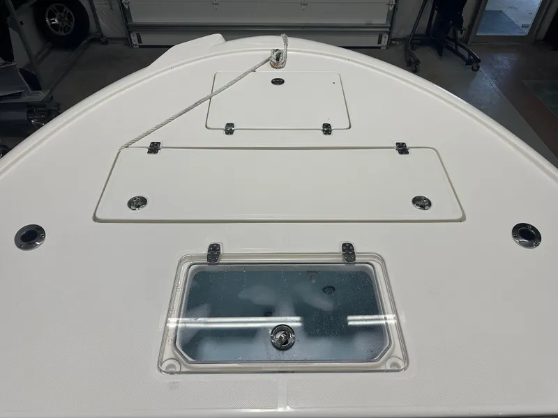 Slide: The Image of 2023 Sea Born FX 25 boat deck with storage compartments and rope. - 35