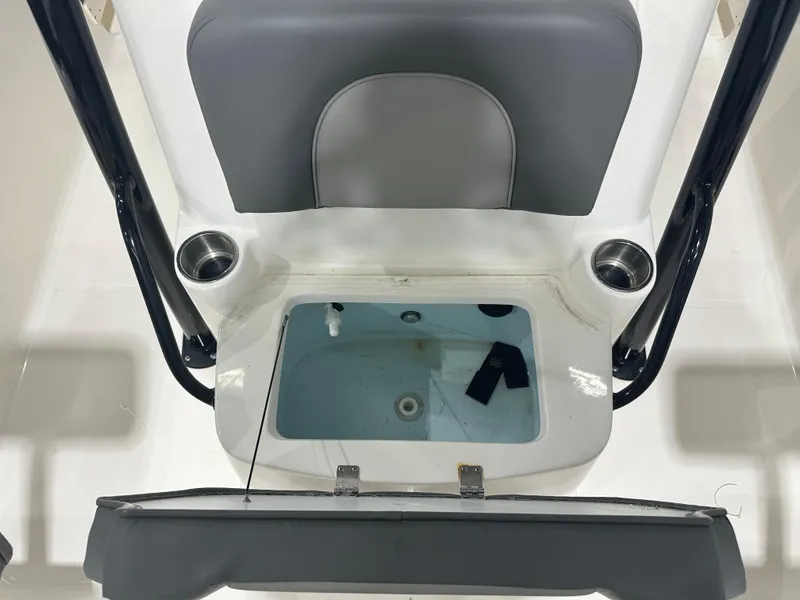 Slide: The Image of 2023 Sea Born FX 25 boat interior with open storage compartment and cup holders. - 44