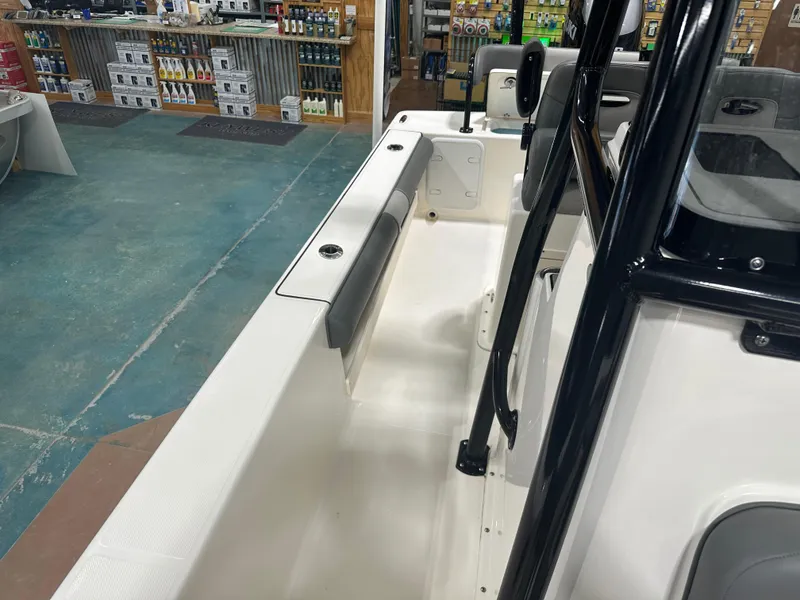 Slide: The Image of 2023 Sea Born FX 25 boat interior, showcasing seating and console in a showroom. - 46