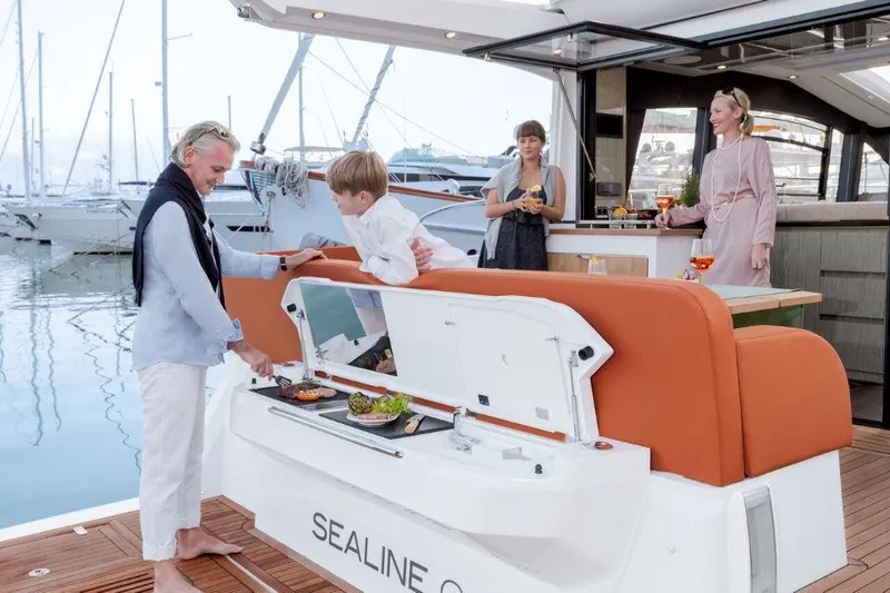 Slide: The Image of 2025 Sealine C430 yacht with people enjoying a meal on deck at a marina. - 15