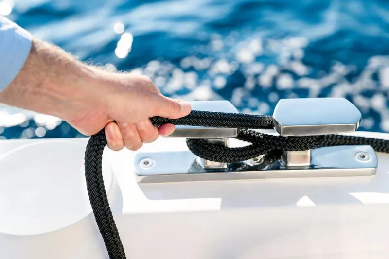 Slide: The Image of Hand securing rope on 2025 Sealine C430 yacht, with ocean in background. - 19