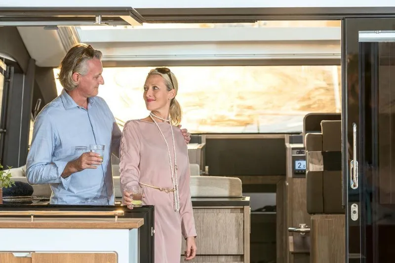 Slide: The Image of Couple enjoying drinks on a 2025 Sealine C430 yacht interior. - 25