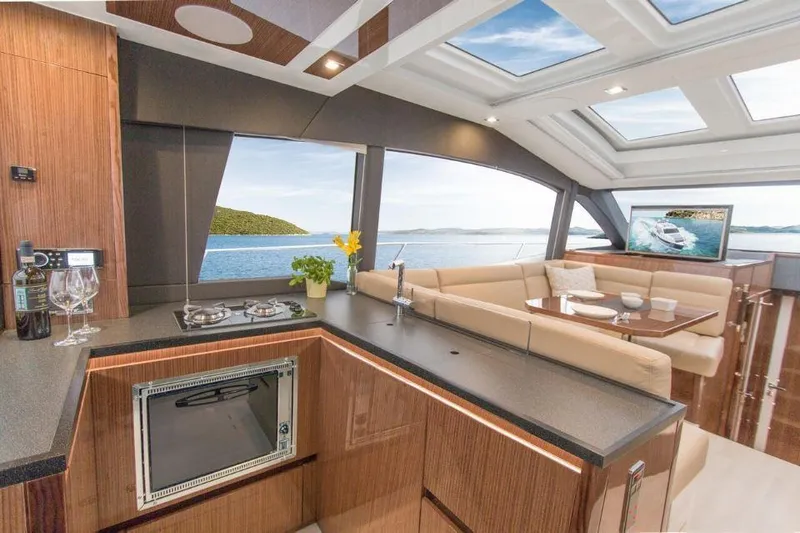 Slide: The Image of Luxurious interior of 2025 Sealine C430 yacht with modern kitchen and scenic ocean view. - 27