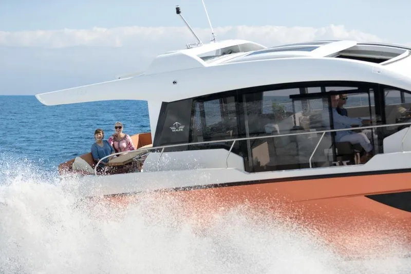 Slide: The Image of 2025 Sealine C430 yacht cruising on open water with passengers enjoying the ride. - 6