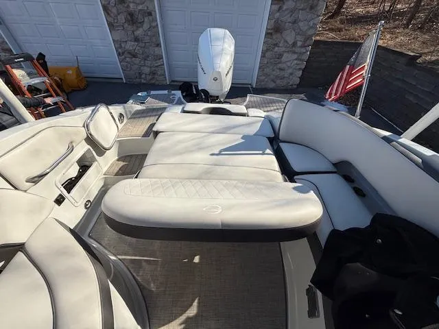 Slide: The Image of 2020 Crownline Eclipse E255 XS boat interior with spacious seating and American flag. - 10