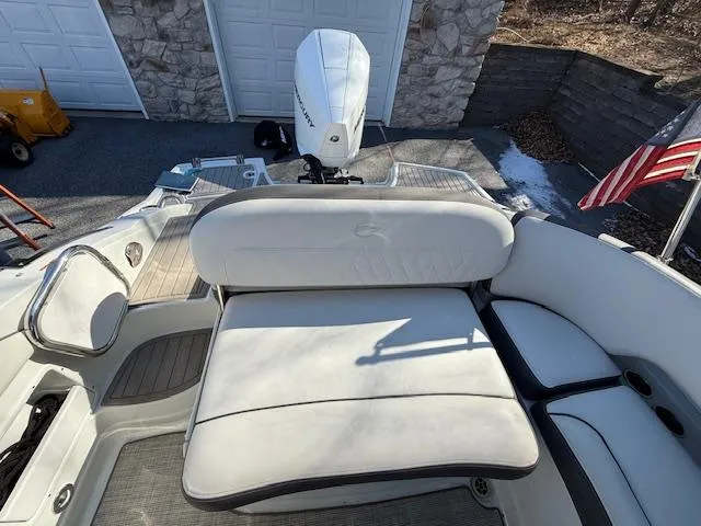 Slide: The Image of 2020 Crownline Eclipse E255 XS boat interior with seating and outboard motor. - 11