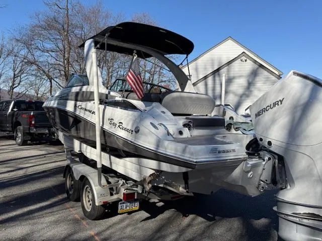 Slide: The Image of 2020 Crownline Eclipse E255 XS boat on trailer with Mercury engine, parked outdoors. - 3