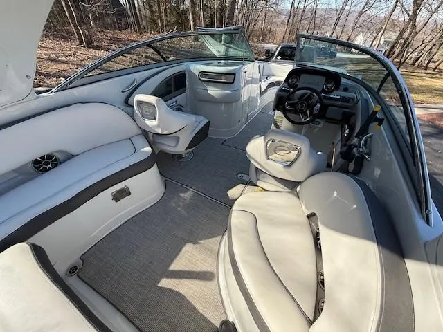 Slide: The Image of 2020 Crownline Eclipse E255 XS boat interior with plush seating and modern dashboard. - 8