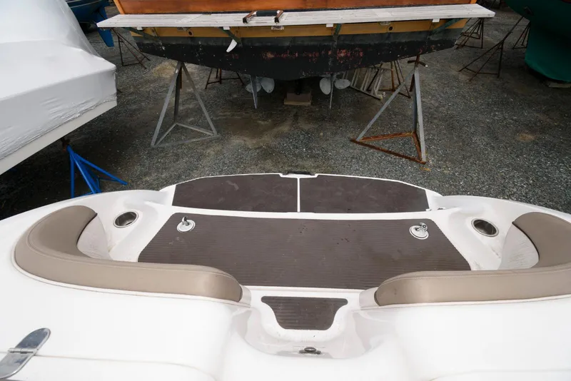 Slide: The Image of 2011 Yamaha Boats 242 Limited swim platform with cushioned seating and storage. - 11