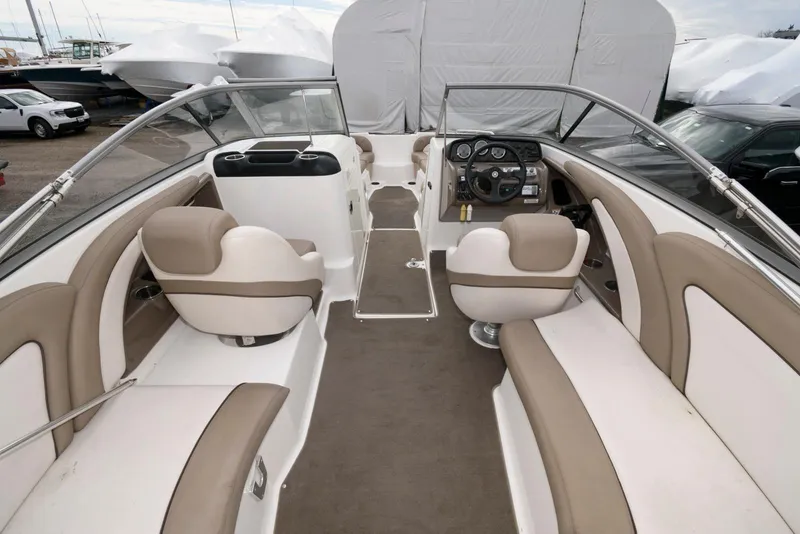 Slide: The Image of 2011 Yamaha Boats 242 Limited interior with beige and white seating, steering console, and open layout. - 3