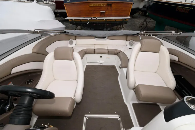 Slide: The Image of 2011 Yamaha Boats 242 Limited interior with beige and white seating. - 7