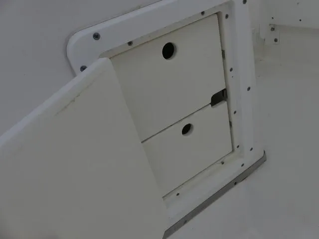 Slide: The Image of 2003 Pro Sports Pro Kat 2860 boat storage compartment with open hatch. - 18