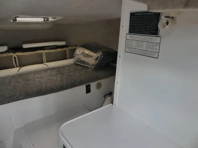 Slide: The Image of Interior cabin of 2003 Pro Sports Pro Kat 2860 boat, featuring a cozy sleeping area. - 22