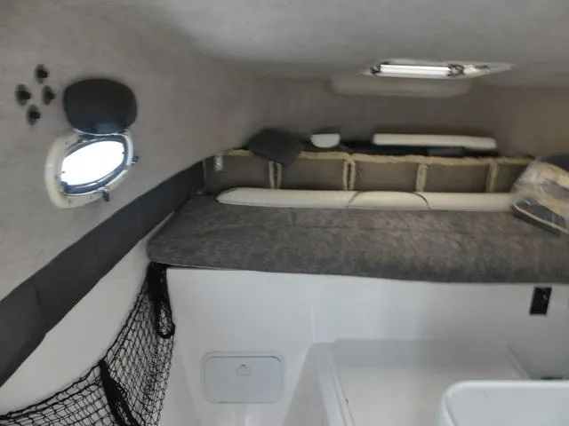 Slide: The Image of Interior cabin of 2003 Pro Sports Pro Kat 2860 boat with sleeping area and storage. - 23