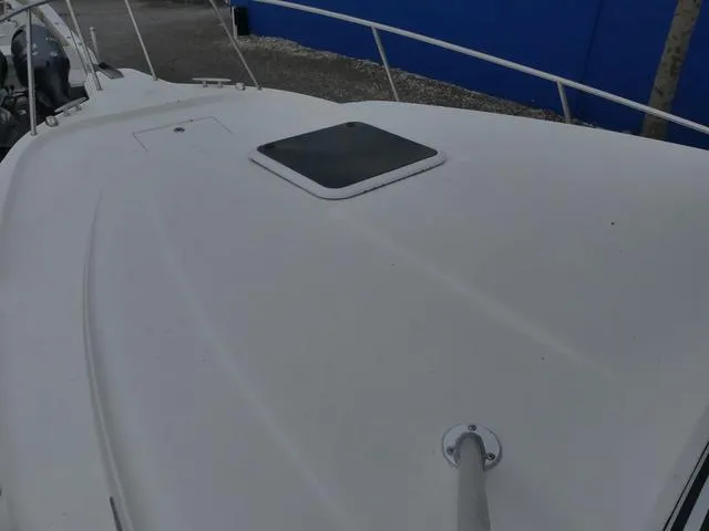 Slide: The Image of 2003 Pro Sports Pro Kat 2860 boat deck with hatch, white surface, and railing. - 24