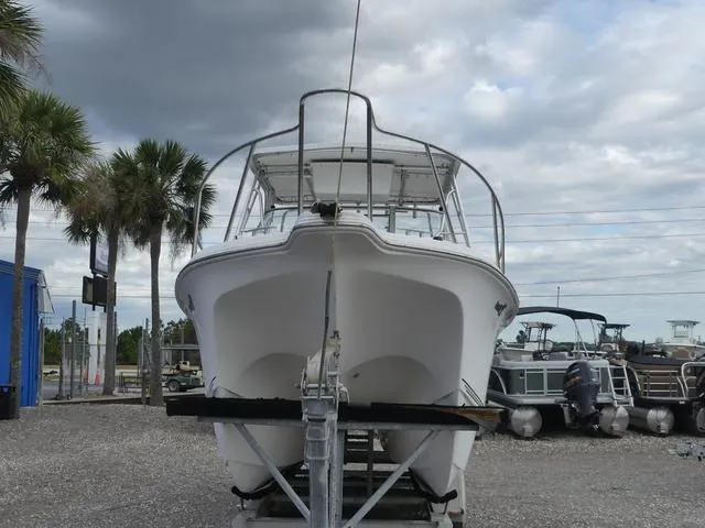 Slide: The Image of 2003 Pro Sports Pro Kat 2860 boat on trailer, parked outdoors under cloudy sky. - 3