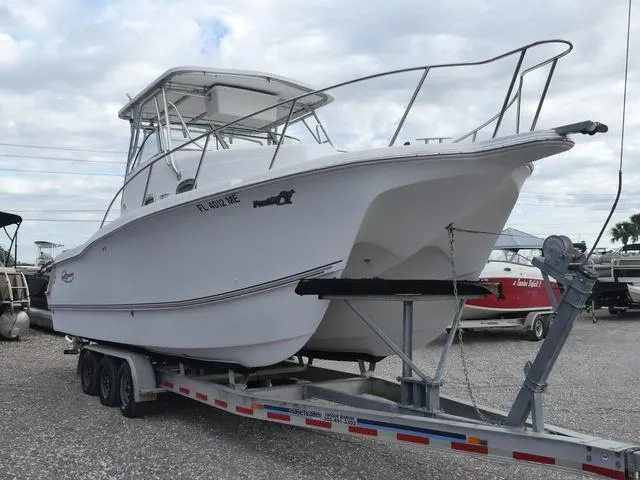 Slide: The Image of 2003 Pro Sports Pro Kat 2860 boat on trailer, white hull, parked outdoors. - 4