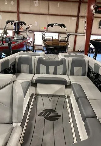 Slide: The Image of 2021 Malibu 23 LSV boat interior with gray seating in showroom. - 4