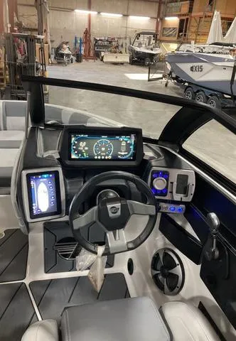 Slide: The Image of 2021 Malibu 23 LSV boat dashboard with modern controls and digital displays. - 6