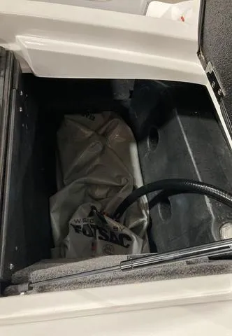 Slide: The Image of 2021 Malibu 23 LSV storage compartment with ballast bag. - 7