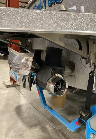 Slide: The Image of 2021 Malibu M240 boat propeller and exhaust system in a garage setting. - 3