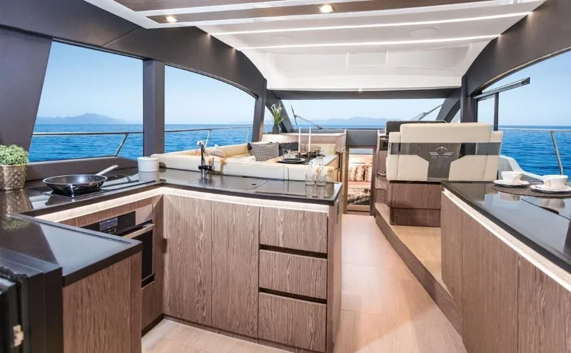 Slide: The Image of Luxurious interior of 2025 Sealine F430 yacht with modern kitchen and ocean view. - 18
