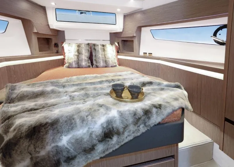 Slide: The Image of Luxurious interior of 2025 Sealine F430 yacht with cozy bedding and elegant decor. - 22