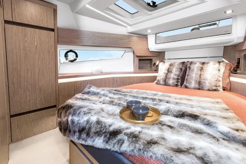 Slide: The Image of Luxurious bedroom interior of 2025 Sealine F430 yacht with plush bedding and modern design. - 23