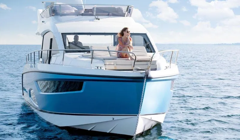 Slide: The Image of 2025 Sealine F430 yacht cruising on open water under a clear blue sky. - 3