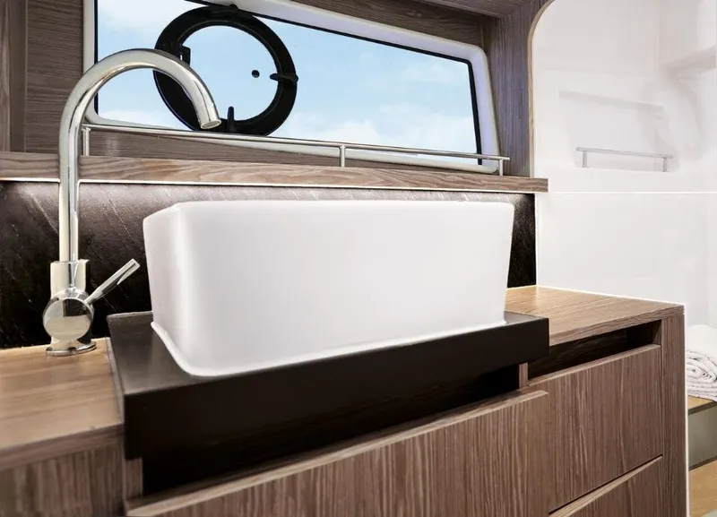 Slide: The Image of Modern bathroom sink in 2025 Sealine F430 yacht, featuring sleek design and wood accents. - 30