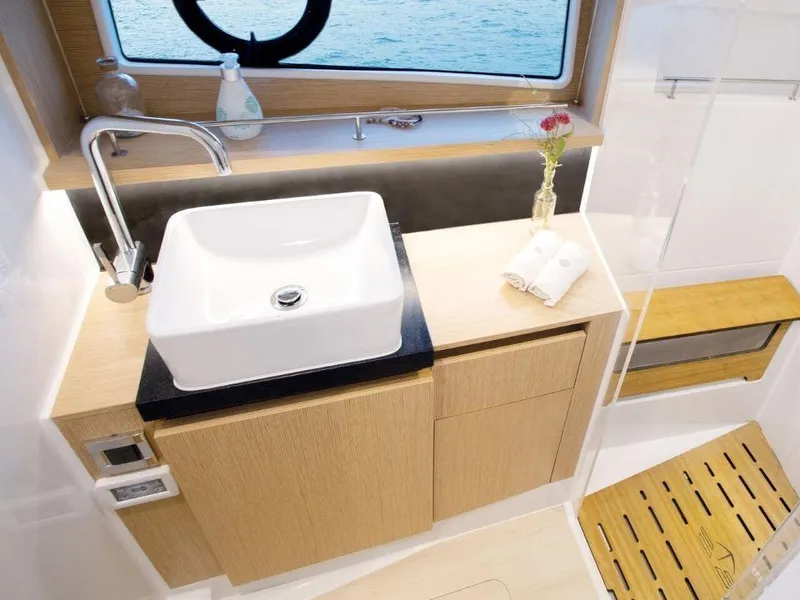 Slide: The Image of Modern bathroom interior of 2025 Sealine F430 yacht with sleek sink and wooden cabinetry. - 31